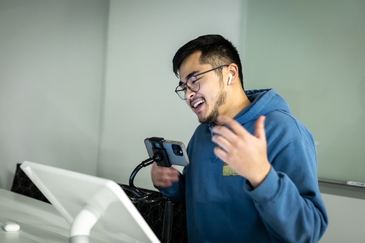 Man holding a cellphone, talking