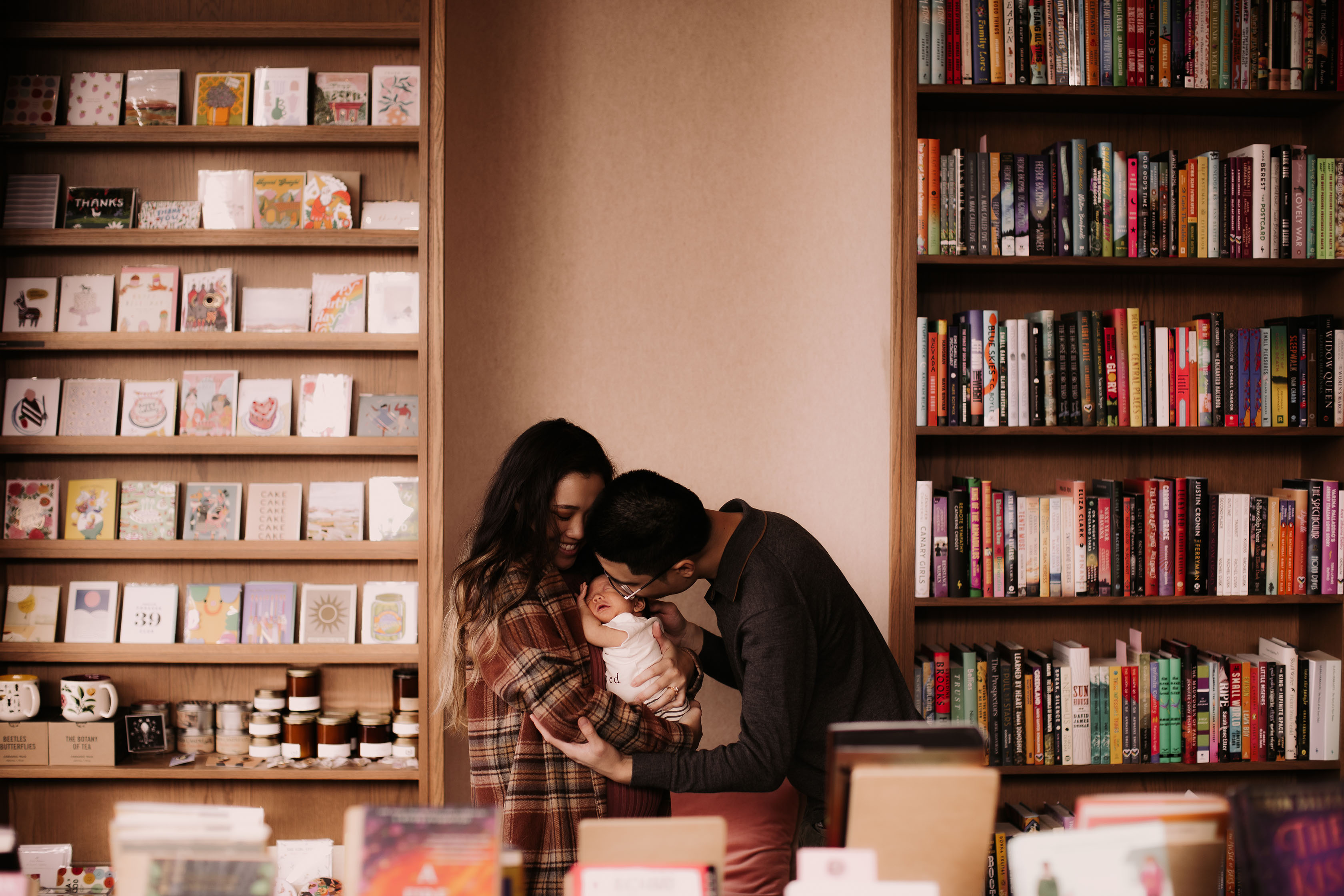 Linzi and Gooi standing in the bookstore looking at their baby