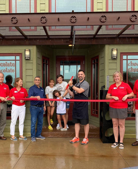 Ben at a ribbon cutting ceremony for his chocolate shop opening