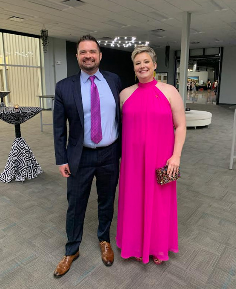Gabe and Caitlin Wells dressed for a formal event.